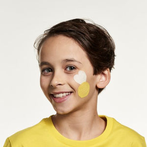 Step one, Using a brush, painting a bright yellow circle on the cheek, then painting two wings above the yellow circle with white.