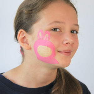 For step 2, mix together ochre and white paint and use that to fill in the face and ears of your furry monster.