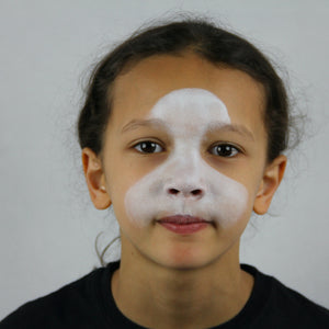Step one, showing the start of creating purple base to both eyes and white base along forehead to mouth.
