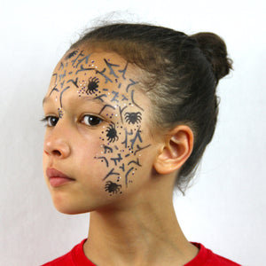 Final step, using white paint adding small dots to complete the Spiderweb Stencil face paint