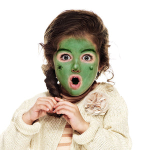 Step two, covering the face in grass green with a sponge, then using a brush to paint thick black eyebrows.