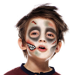 Final step, adding crooked teeth with white paint and red highlights of blood to complete Zombie face paint.