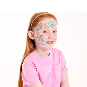 Add blue and white petals around the leaves by pressing the brush flat, lifting, and flicking downward.