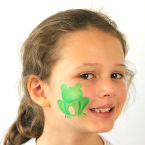 Step one, showing the start of creating frog base on cheek using green face paint.