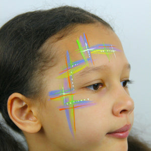 Step one, creating lines in forehead and cheeks using lilac, white, blue and lime green.