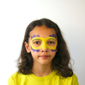 Step two, adding half circles on the top and bottom of mask using purple face paint.
