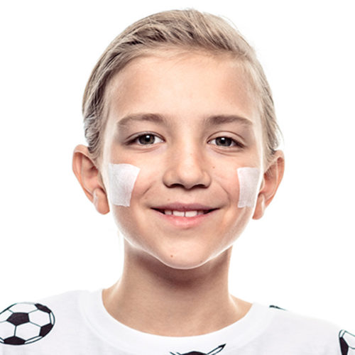 Boy with step 1 of english flag face paint design