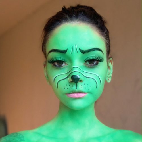 girl with step 2 of Grinch Christmas face paint design