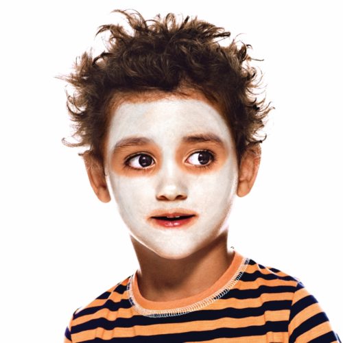 Boy with step 1 of Cheeky Skeleton Halloween face paint design