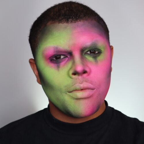 Boy with step 1 of Neon Skull face paint design for Halloween