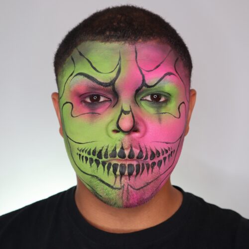 Boy with step 2 of Neon Skull face paint design for Halloween