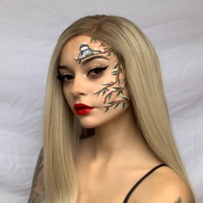 Woman with holly branch face paint design