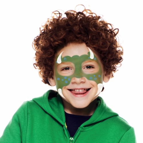 Boy with step 2 of Dinosaur Boy face paint design