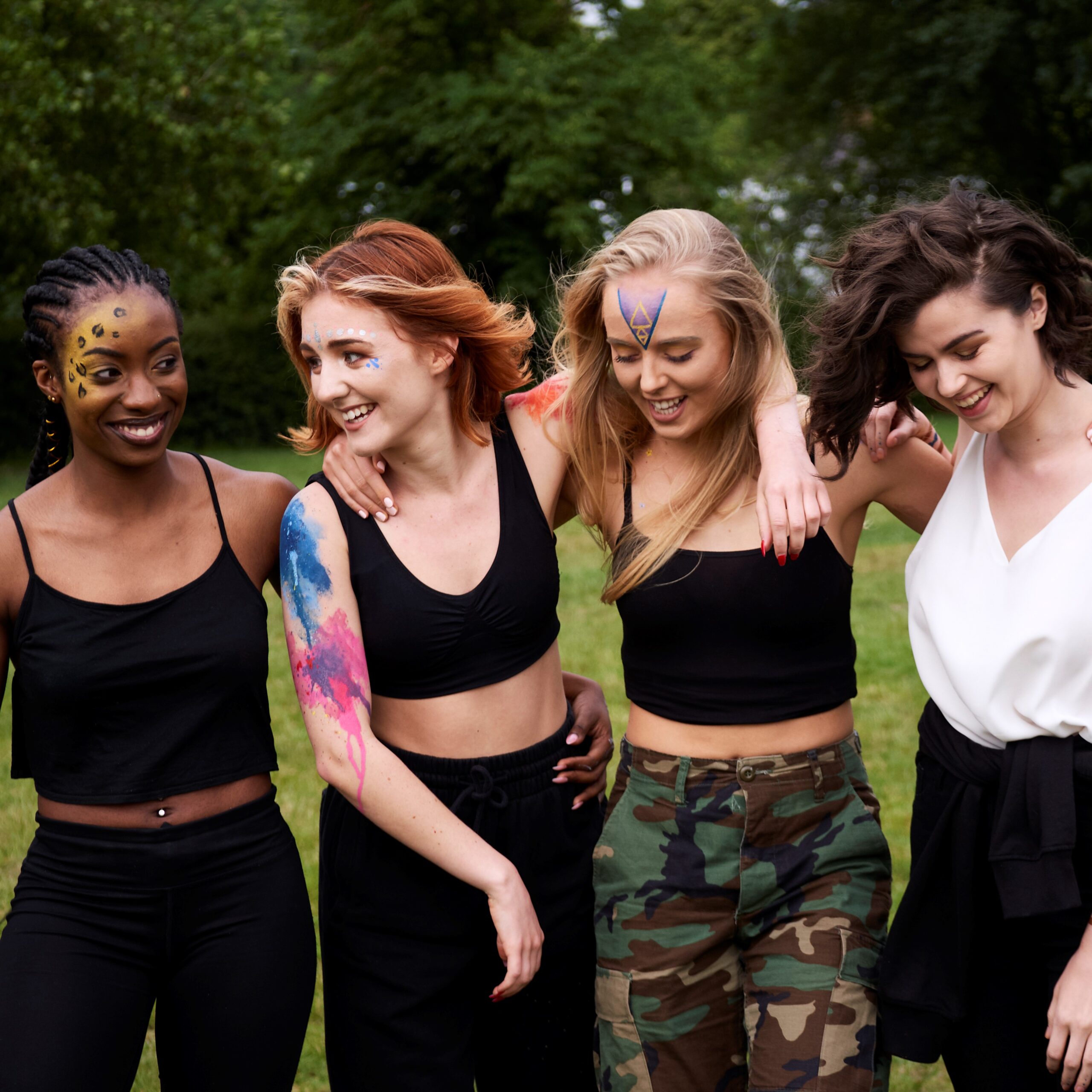 Group of girls with face and body paint on at a festival