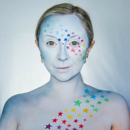 girl with step 2 of Shooting Star face paint design