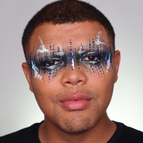 Boy with step 2 of Glitter Mask face paint design for Halloween