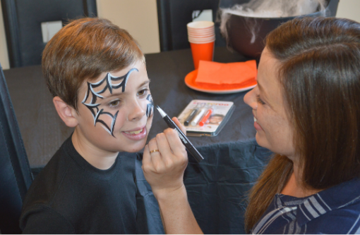 boy getting face painted